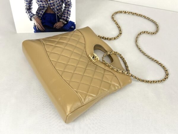 Chanel 24S Beige Shiny Crumpled Lambskin Mini 31 Bag with Champagne Gold Hardware.